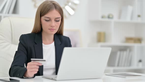 Online Payment Success on Laptop for Businesswoman in Office