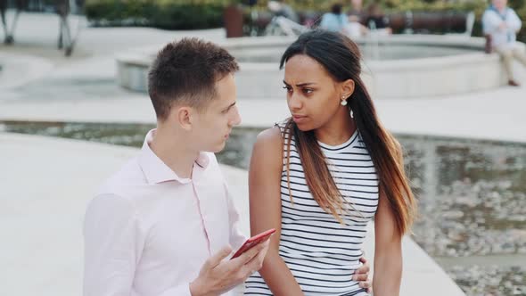 Multiracial Young Woman Waiting Her Boyfriend Begin Talking and Leave His Smartphone