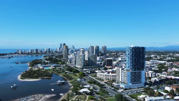 Modern towering high-rises built on the foreshore of a popular coastal city town. High drone view