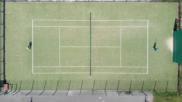 The camera rises above the tennis court