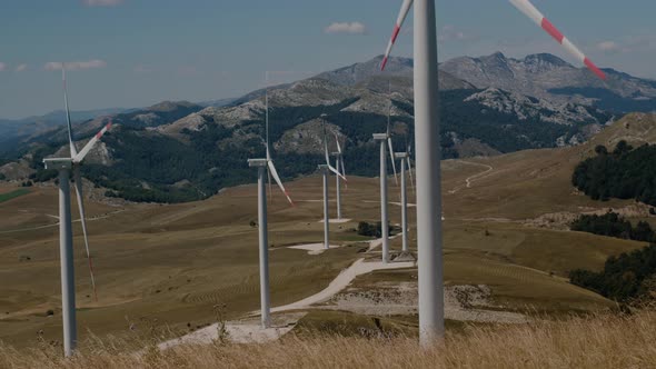 Windmill Park with large turbines with blades in field, Alternative energy