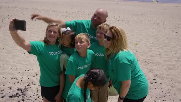 Volunteers taking photo together at beach cleanup