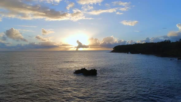 Sunrise Over A Picturesque Coastline with the Sun Rising Over the Sea