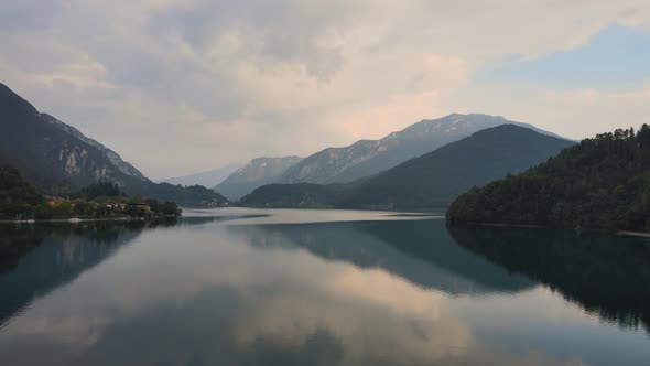 Grandiose mountain land watches carefully about peaceful and fascinating pretty lake ledro