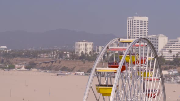 Aerial view of Pacific wheel and amusement wheel on Santa Monica coast