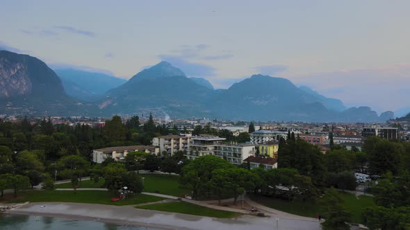 Aerial view of Riva del Garda city, overview at sunrise. Slide shot in 4k