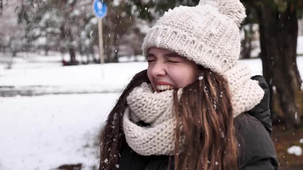 Happy woman enjoying snow in winter