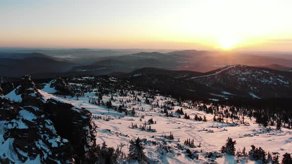 Aerial Motion Above Mountain with Ski Tracks on Snowy Slopes