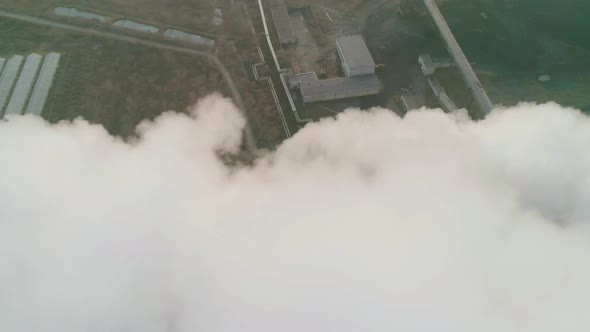 Aerial Orbital View of an Industrial Zone Pipes Pouring Thick White Smoke