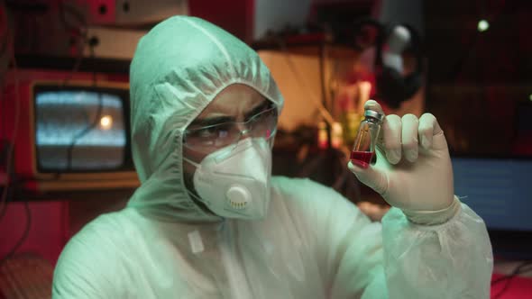 Man Chemist Holding Ampules Closeup
