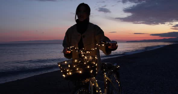 Girl with a Bicycle near the Ocean