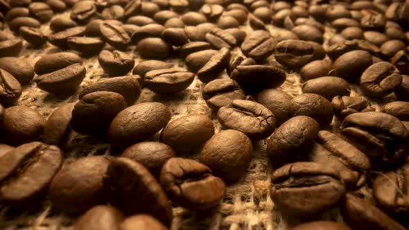 Dark Brown Roasted Coffee Beans Lying on Burlap