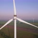 Windmills with rotating wings among green fields. Wind farm for wind energy. - VideoHive Item for Sale