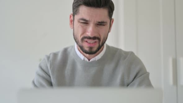 Close Up of Man Having Neck Pain While Using Laptop