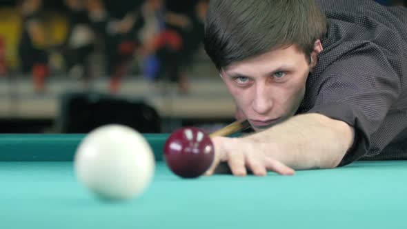 Guy Takes Aim, To Make an Impact on a Billiard Ball. Slow Motion