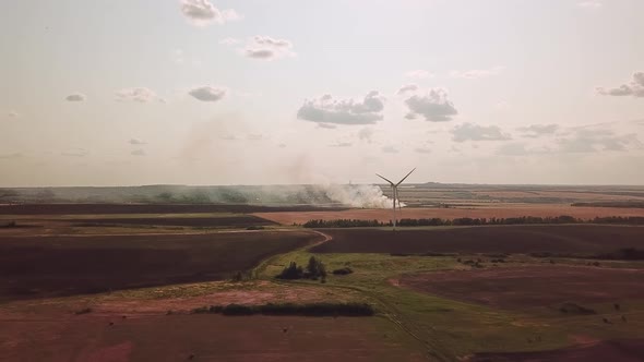 Wind Farms in the Field and a Burning Weald