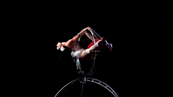 Two Woman in Makes Element in the Aerial Hoop. Black Background. Slow Motion