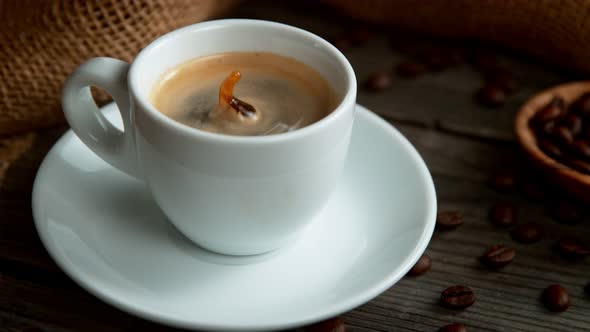 Super Slow Motion Shot of Coffee Drop Falling Into Cup of Espresso at 1000 Fps