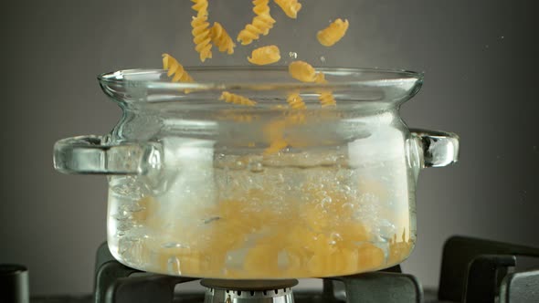 Super Slow Motion Shot of Fresh Fusilli Falling Into Boiling Salted Water at 1000 Fps.