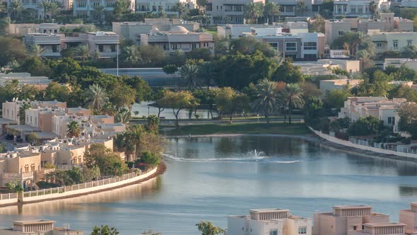 Aerial View to Villas and Houses with Golf Course with Green Lawn and Lakes Timelapse