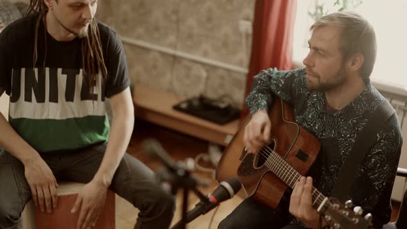 Male Musicians Rehearsing Together at Home