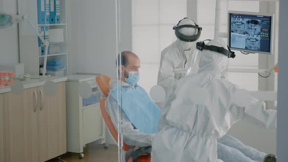 Dentistry Staff Wearing Ppe Suits Doing Teethcare Consultation