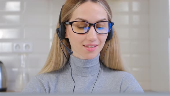 Online support specialist in headset talking on web camera with cheerful smile in 4k video