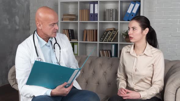 Young Hispanic Woman Looking Test Results Male Senior Doctor