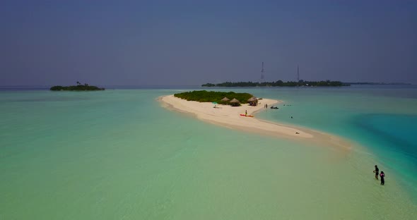 Wide angle aerial tourism shot of a white paradise beach and aqua blue water background in high reso