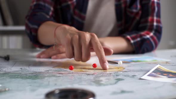 Points On Route In Map Marked With Red White Buttons On Map. Woman's Hand Leads Finger On World Map