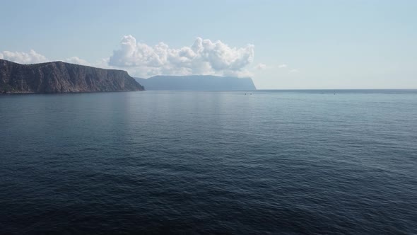 Aerial View From Above on Calm Azure Sea and Volcanic Rocky Shores