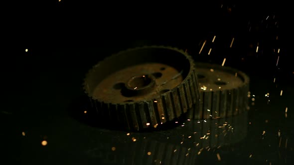Sparks with gears in ultra slow motion 1500fps on a reflective surface - SPARKS w GEARS 