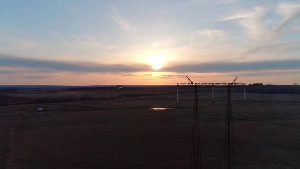 Aerial Video of the Electric Pole with Wires Against Sky at Sunset