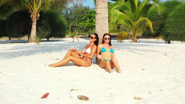 Girls tan on paradise coastline beach voyage by clear water and white sand background of Koh Phangan