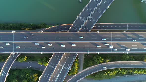 Aerial Drone View of Highway Multi-level Junction Road with Moving Car at Sunset. Active Movement