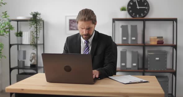 Businessman Working on Laptop at Office