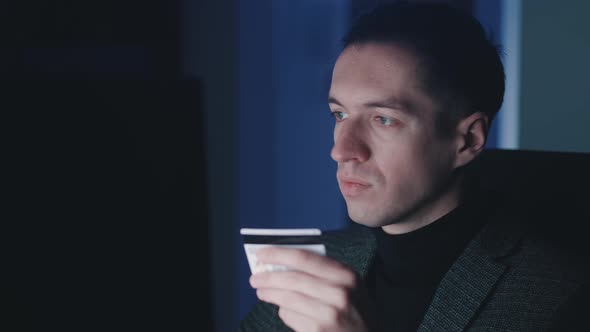 Young Man Entrepreneur Using Computer Laptop and Shopping Online with Credit Card While Sitting at