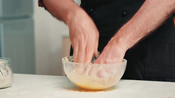 Chef Kneading Dough in Bowl