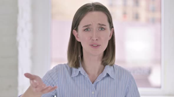 Portrait of Young Woman Feeling Shocked and Shaking Head