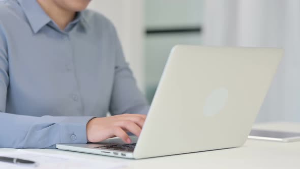 Close Up of African Woman Typing on Laptop