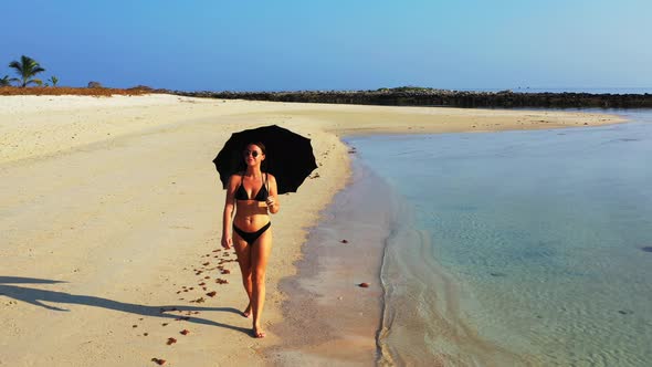 Sexy fun women on holiday spending quality time at the beach on paradise white sand and blue 4K back