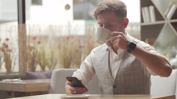 Businessman sitting and working in a cafe. Man using computer.