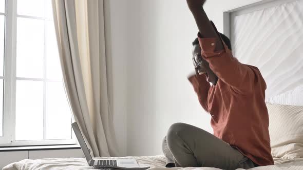 Funny AfricanAmerican Man Screams with Joy at Modern Laptop