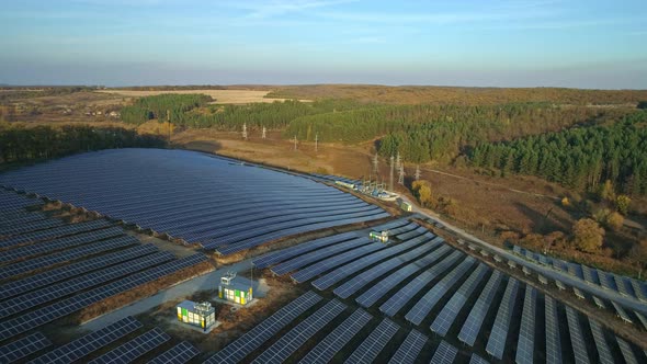 Aerial Drone Footage. Radial Flight Over Solar Panel Farm at Sunset Autumn Season.