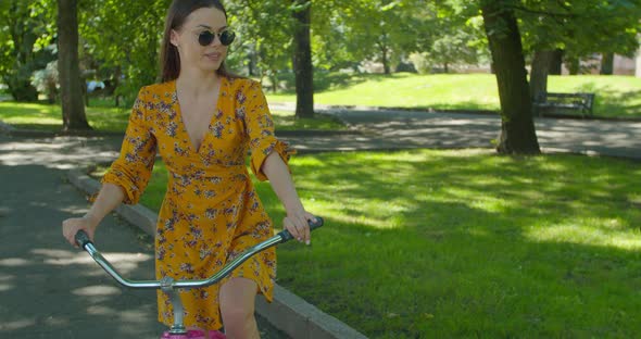 Cycling In City Park. Pretty Lady Moving On Bicycle. Cyclist Girl Workout Riding On Bicycle In