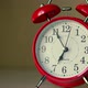 Red Alarm Clock on a White Nightstand Time 655 - VideoHive Item for Sale