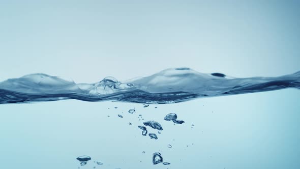 Water surface splashing and bubble rising. Slow Motion.