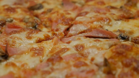 Tasty baked pizza surface close-up slow pan 4K 2160p 30fps UltraHD footage - World famous Italian pi