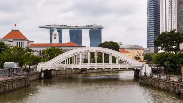 Timelapse of bridge over Singapore River with Victoria Theatre and Marina Bay Sands