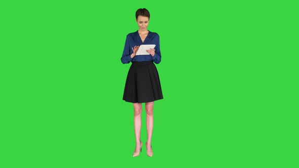 Businesswoman Working on Digital Tablet on a Green Screen, Chroma Key.